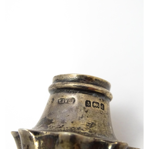 431 - A silver pepper of shaped form hallmarked Birmingham 1903, maker Turnbull Bros. Together with a silv... 