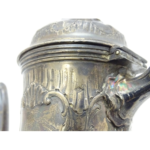 539 - A French silver coffee pot with acanthus scroll decoration and laurel chaplet formed finial. Approx.... 