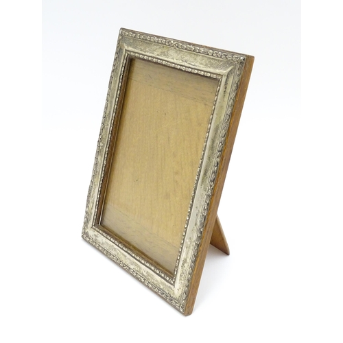 665 - An easel back photograph frame with silver surround hallmarked Birmingham 1910 , maker Henry William... 