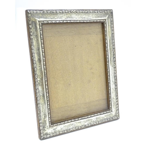 665 - An easel back photograph frame with silver surround hallmarked Birmingham 1910 , maker Henry William... 