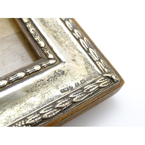 665 - An easel back photograph frame with silver surround hallmarked Birmingham 1910 , maker Henry William... 