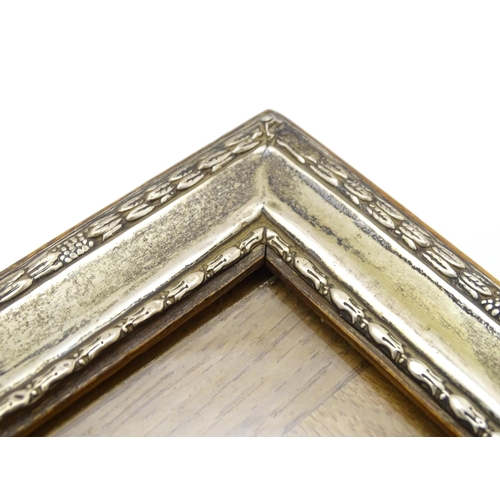 665 - An easel back photograph frame with silver surround hallmarked Birmingham 1910 , maker Henry William... 