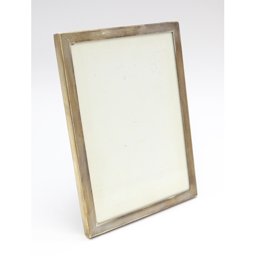 665A - An easel back photograph frame with silver surround hallmarked Birmingham 1962, maker Sanders & Mack... 