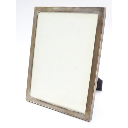 665A - An easel back photograph frame with silver surround hallmarked Birmingham 1962, maker Sanders & Mack... 