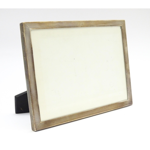 665A - An easel back photograph frame with silver surround hallmarked Birmingham 1962, maker Sanders & Mack... 