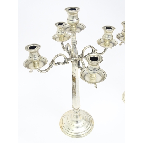 667 - A pair of silver plate five branch candelabra / candelabrum. Approx. 23