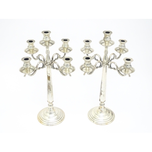 667 - A pair of silver plate five branch candelabra / candelabrum. Approx. 23