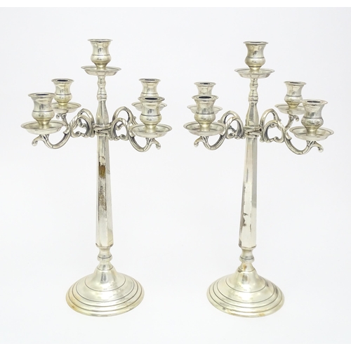 667 - A pair of silver plate five branch candelabra / candelabrum. Approx. 23