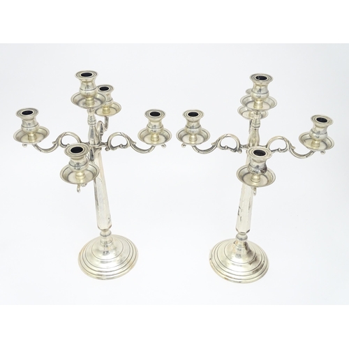 667 - A pair of silver plate five branch candelabra / candelabrum. Approx. 23