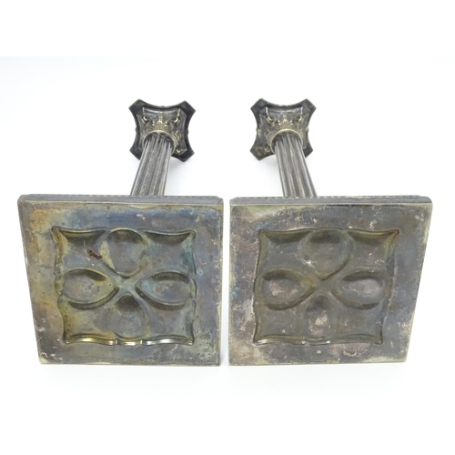 676 - A pair of silver plate candlesticks of column form with swag decoration. Approx. 12