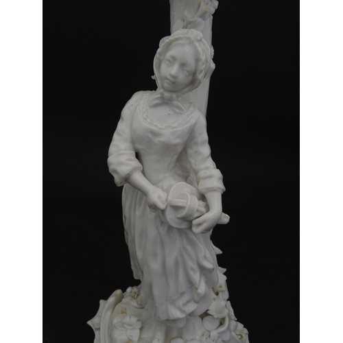 76 - A Continental figural candelabra depicting a woman on a naturalistic base with a tree. Bears Meissen... 