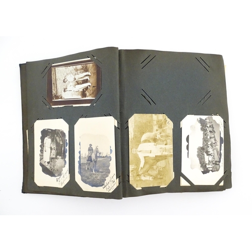 2141 - An early 20thC photograph and postcard album containing various South American scenes to include Esp... 