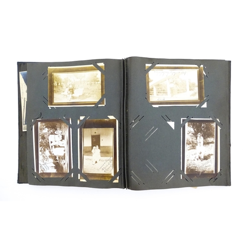 2141 - An early 20thC photograph and postcard album containing various South American scenes to include Esp... 