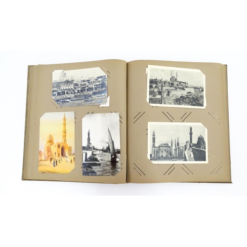 2143 - A 20thC postcard / greetings card album to include humorous examples, topographical views, church in... 