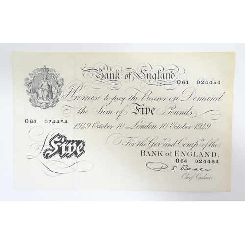 2160 - A 20thC Bank of England white five pound note dated 10th October 1949, signed by P. S. Beale and num... 