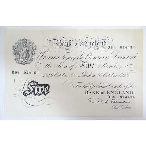 2160 - A 20thC Bank of England white five pound note dated 10th October 1949, signed by P. S. Beale and num... 