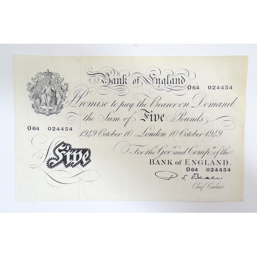 2160 - A 20thC Bank of England white five pound note dated 10th October 1949, signed by P. S. Beale and num... 