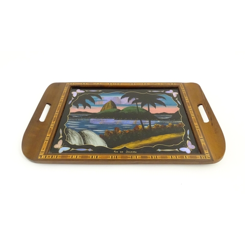 1270 - A 20thC Brazilian twin handled tray set with central scene depicting a Rio de Janeiro view with butt... 