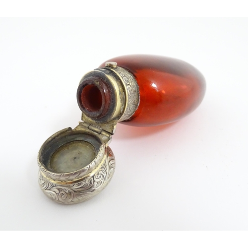 208 - A 19thC cranberry glass scent bottle / perfume flask with white metal top, maker GB. Approx. 3 1/2