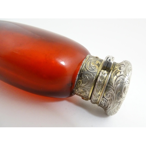 208 - A 19thC cranberry glass scent bottle / perfume flask with white metal top, maker GB. Approx. 3 1/2