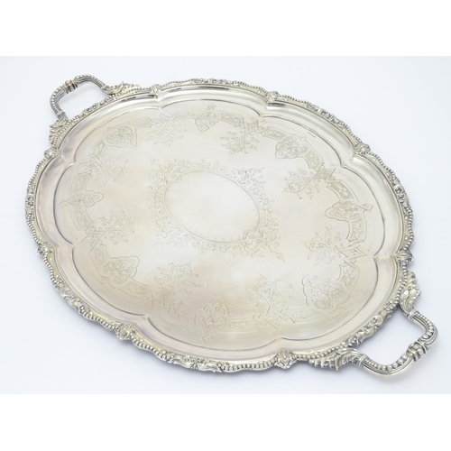 672 - A quantity of assorted silver plate items comprising an exceptionally large twin handled tray, a tea... 