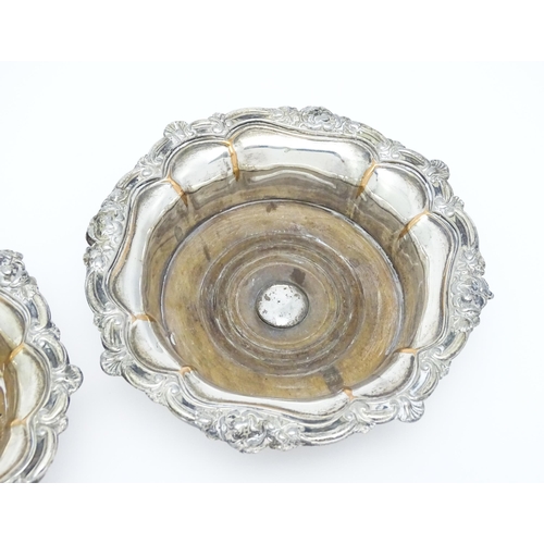 680 - A pair of 19thC silver plate bottle coasters with turned wooden bases. Together with a pair of silve... 