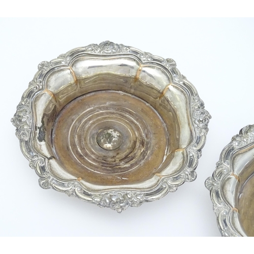 680 - A pair of 19thC silver plate bottle coasters with turned wooden bases. Together with a pair of silve... 