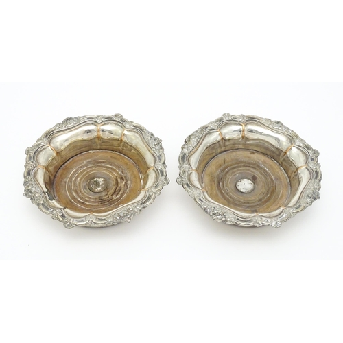 680 - A pair of 19thC silver plate bottle coasters with turned wooden bases. Together with a pair of silve... 