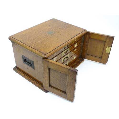 689 - An oak cased cutlery chest / canteen, the twin doors opening to reveal four fitted drawers within, c... 