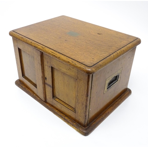 689 - An oak cased cutlery chest / canteen, the twin doors opening to reveal four fitted drawers within, c... 