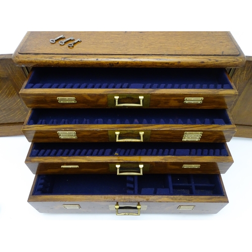 689 - An oak cased cutlery chest / canteen, the twin doors opening to reveal four fitted drawers within, c... 