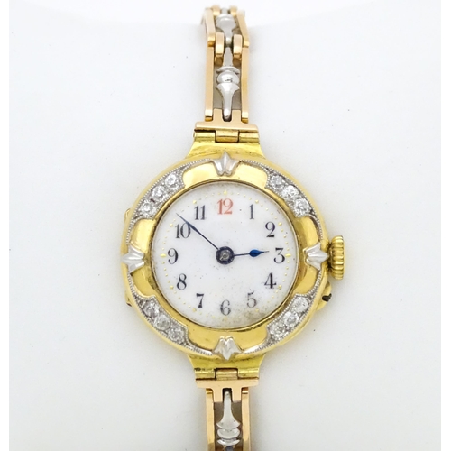 933A - An 18ct gold cased ladies wristwatch set with 12 diamonds, with white enamel dial, and 15ct gold bra... 