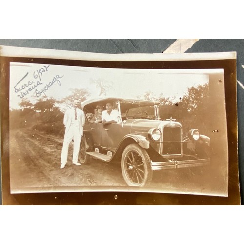 2141 - An early 20thC photograph and postcard album containing various South American scenes to include Esp... 