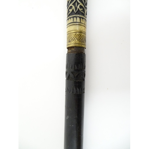 1249 - An early 20thC Indian sword stick with horn handle with brass lion mask pommel, the ebonised shaft w... 