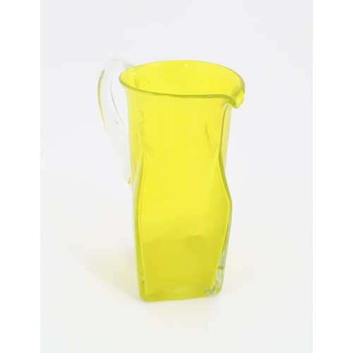 205A - A 20thC yellow glass jug with squared base and clear glass handle. Approx. 8 1/2