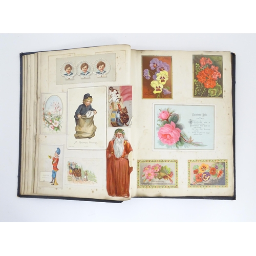 2140 - A late 19th / early 20thC scrapbook / greeting card album containing pressed flowers and foliage, va... 