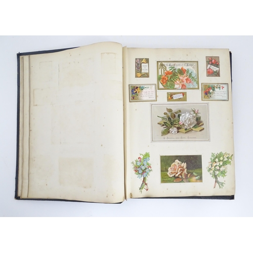 2140 - A late 19th / early 20thC scrapbook / greeting card album containing pressed flowers and foliage, va... 