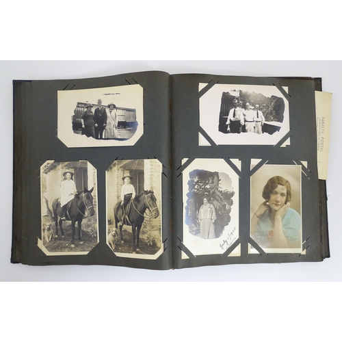 2141 - An early 20thC photograph and postcard album containing various South American scenes to include Esp... 