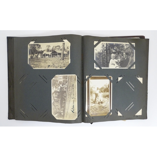 2141 - An early 20thC photograph and postcard album containing various South American scenes to include Esp... 