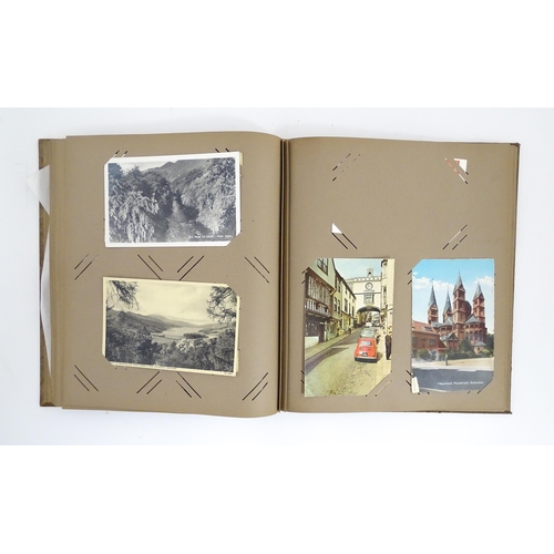 2143 - A 20thC postcard / greetings card album to include humorous examples, topographical views, church in... 