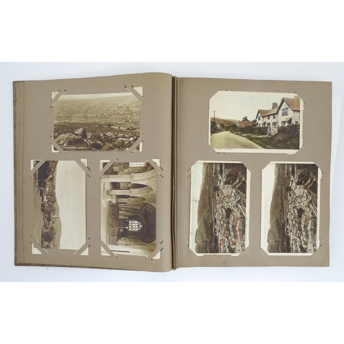 2143 - A 20thC postcard / greetings card album to include humorous examples, topographical views, church in... 