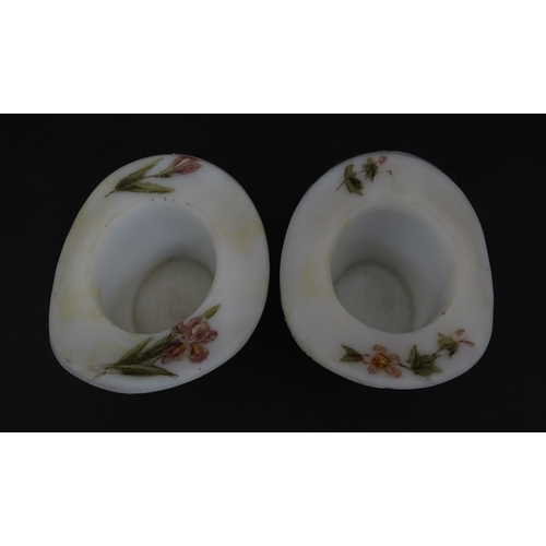 216 - A pair of milk glass match holders / vesta keeps  formed as top hats with hand painted floral detail... 