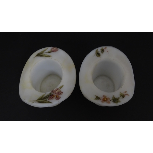 216 - A pair of milk glass match holders / vesta keeps  formed as top hats with hand painted floral detail... 