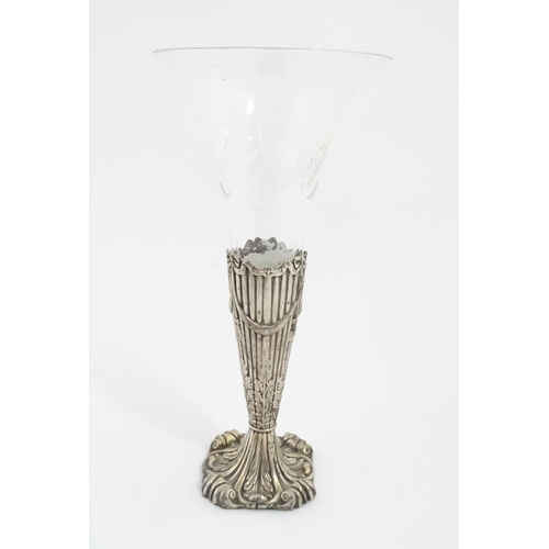 238 - A Victorian glass vase / epergne vase. The glass flute formed vase with silver base decorated with b... 