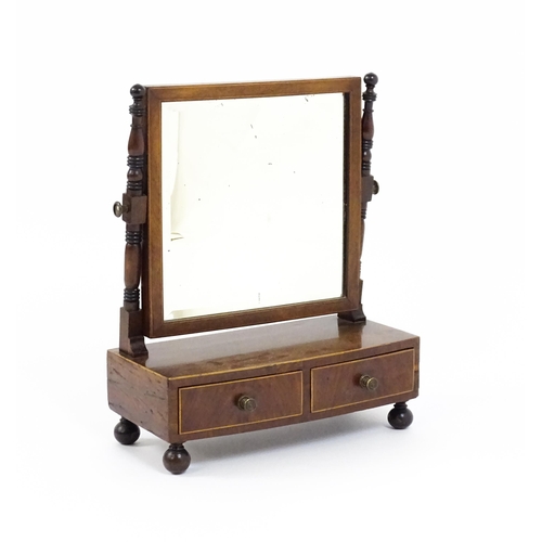 1676 - A 19thC mahogany toilet mirror with a square mirror raised on turned supports with satinwood banding... 