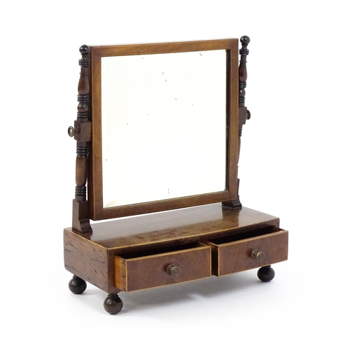 1676 - A 19thC mahogany toilet mirror with a square mirror raised on turned supports with satinwood banding... 