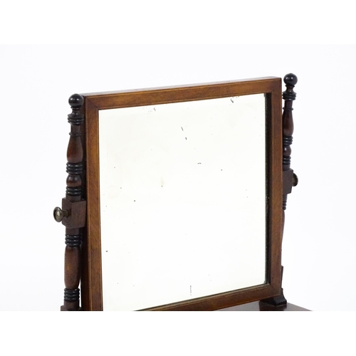 1676 - A 19thC mahogany toilet mirror with a square mirror raised on turned supports with satinwood banding... 