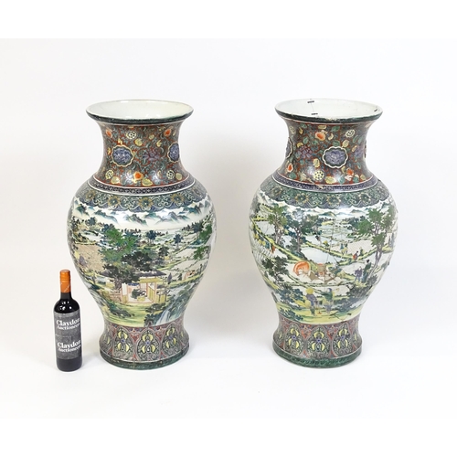 52 - A pair of large Chinese famille verte vases decorated with farming scenes with figures harvesting fi... 