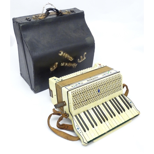 1293 - Musical Instrument : a c1930s Hohner Tango II accordion, the body decorated with floral inlay, 34 ke... 