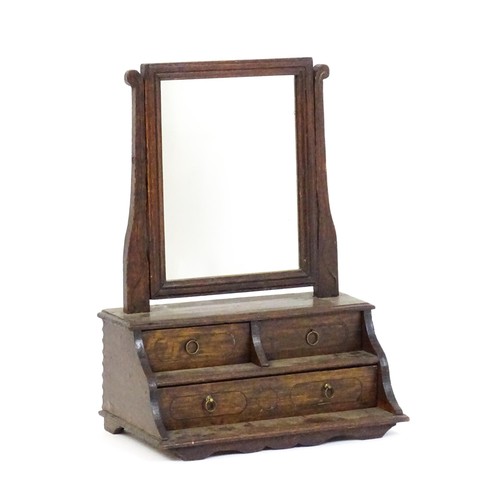 1737 - A mid 18thC oak toilet mirror with a rectangular glass above three short drawers set within a gradua... 